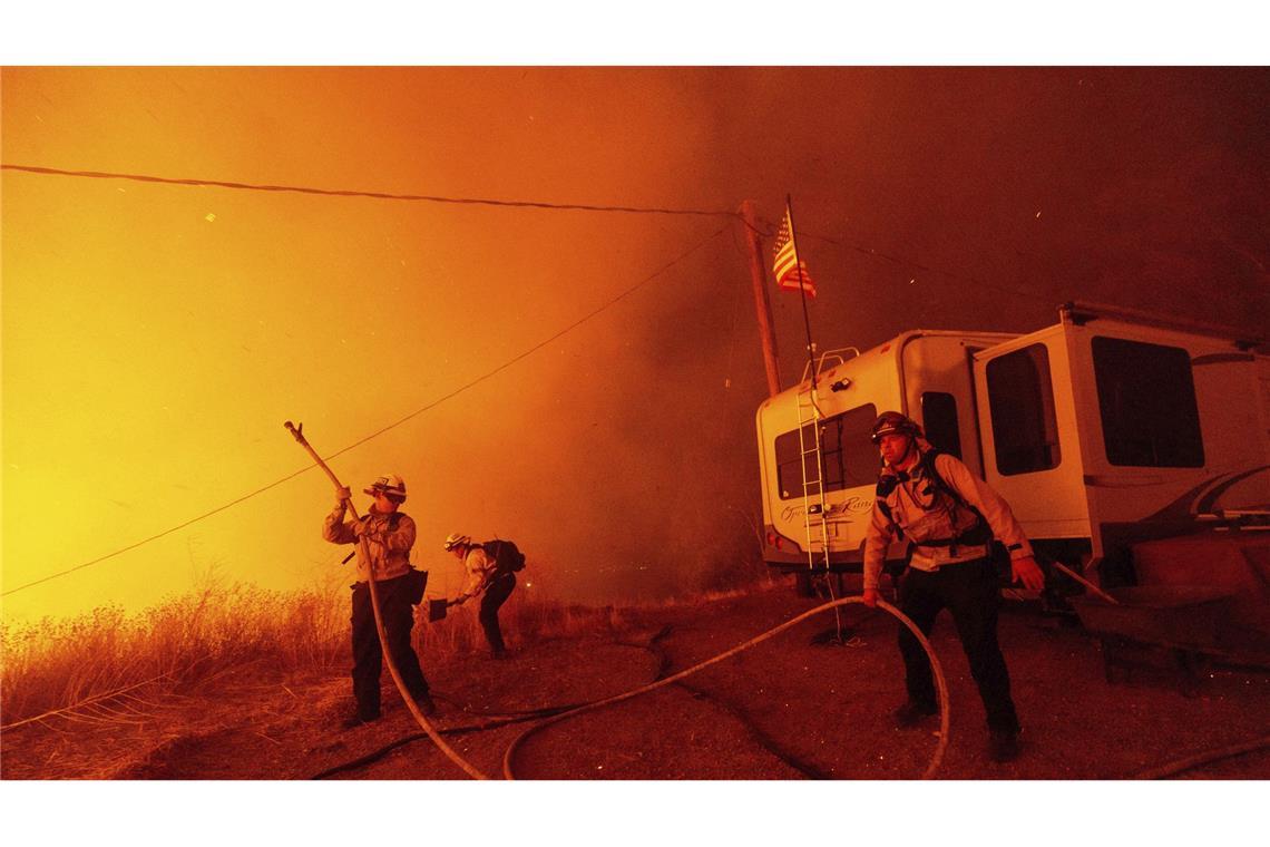 Castaic: Feuerwehrleute sprühen Wasser auf den „Hughes“-Brand.