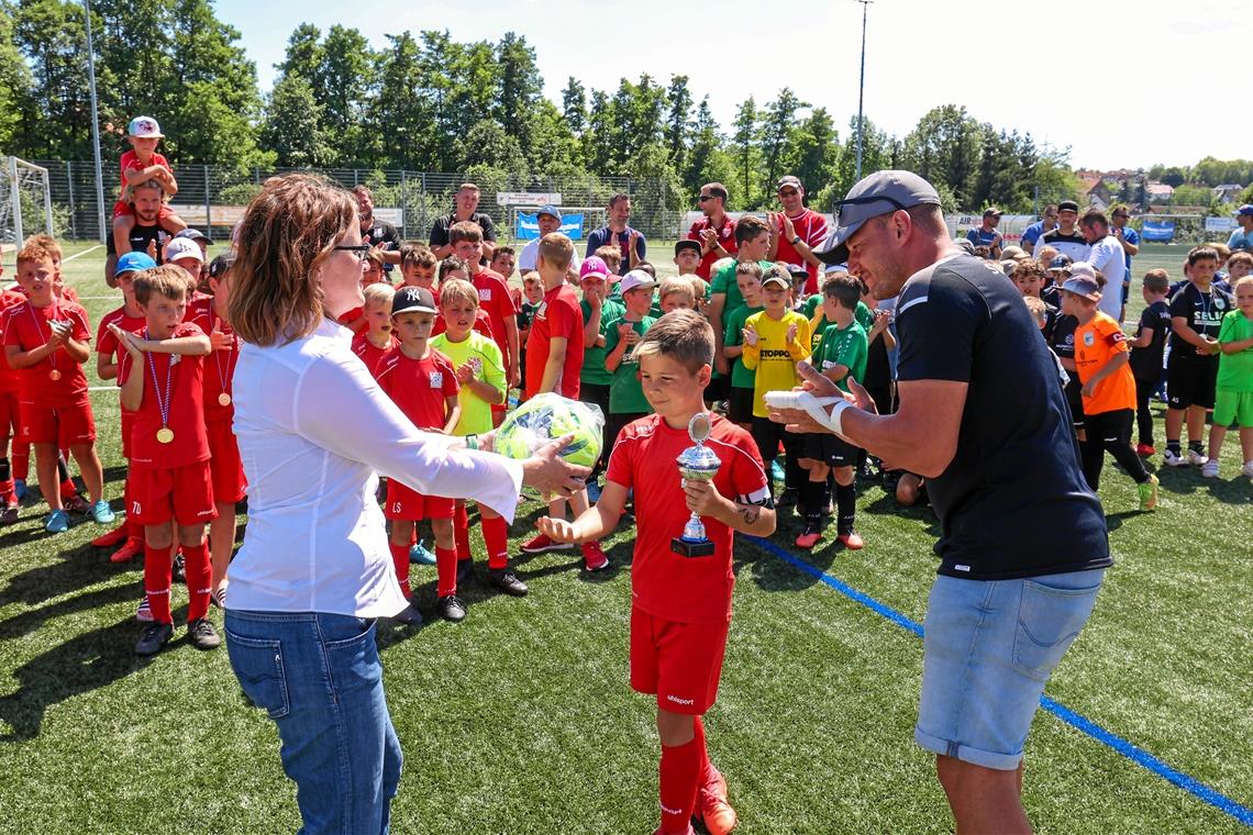 Die Siegerehrung ist der große Moment für die kleinen Talente. Simone Schneider-Seebeck überreicht die vom Sportkreis Rems-Murr gestifteten Bälle, aus den Händen von Steinbachs Jugendleiter Sören Kettner hat der Kapitän seines Teams bereits den Pokal bekommen. Foto: Alexander Becher