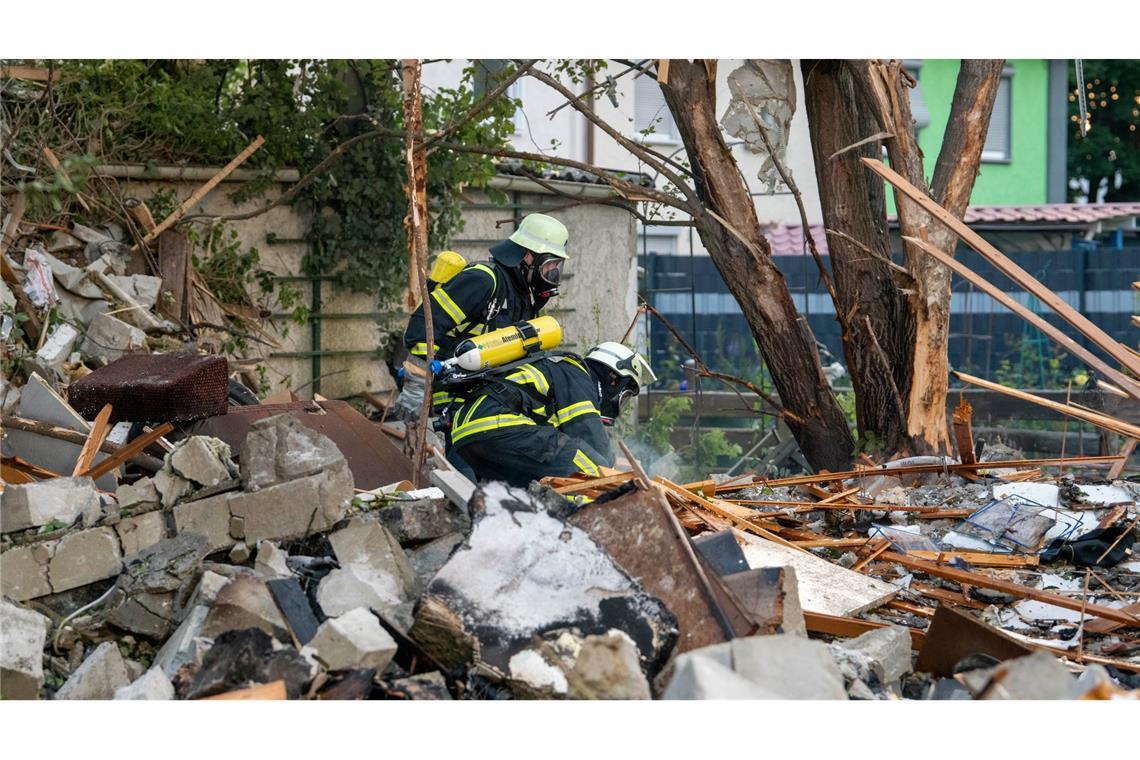 Feuerwehrleute in den Trümmern des zerstörten Hauses.