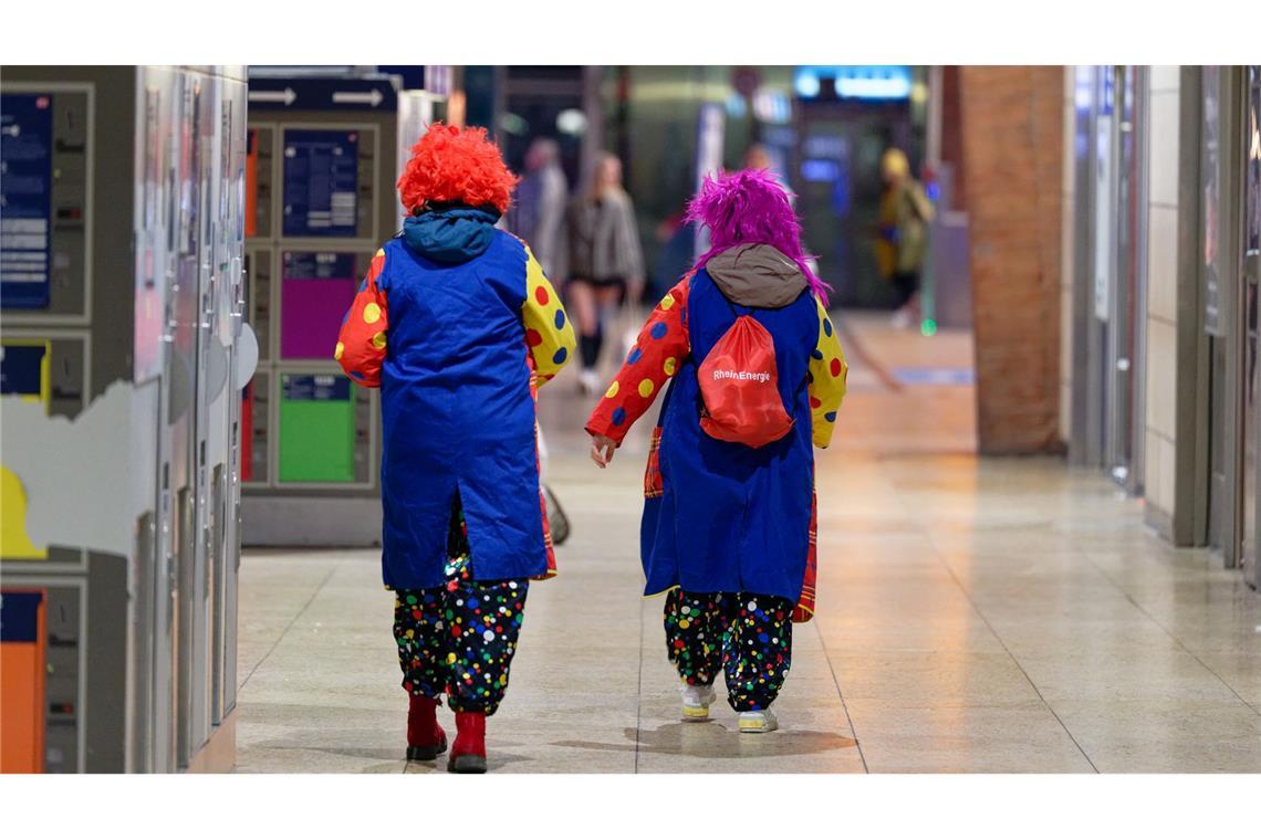 Kölle Allaaf um sieben Uhr: Zum 11.11. mischen sich so manche Clowns unter die Pendler am Kölner Hauptbahnhof.