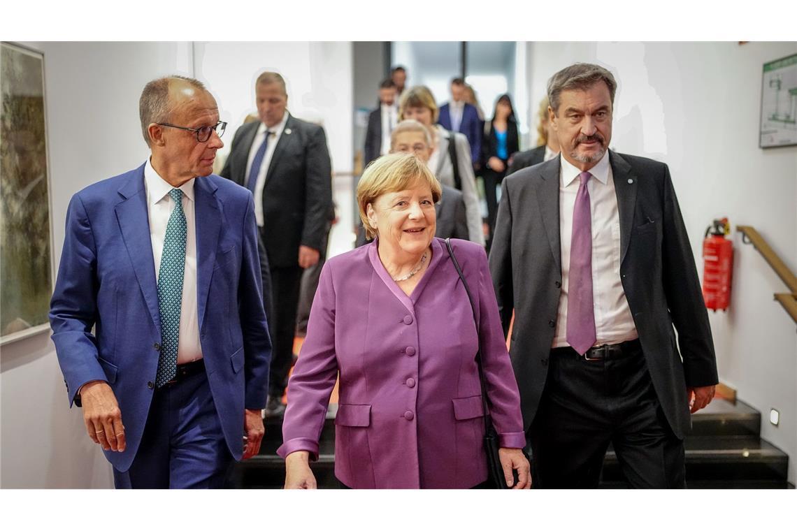 Markus Söder, CSU-Vorsitzender und Ministerpräsident von Bayern, und Friedrich Merz, CDU-Bundesvorsitzender und Unionsfraktionsvorsitzender, begleiteten Altkanzlerin Angela Merkel zu ihrem Platz.