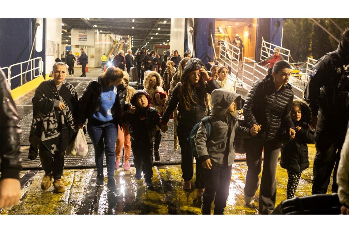 Menschen steigen im Hafen von Piräus von einer Fähre, mit der sie die Insel Santorini verlassen haben.