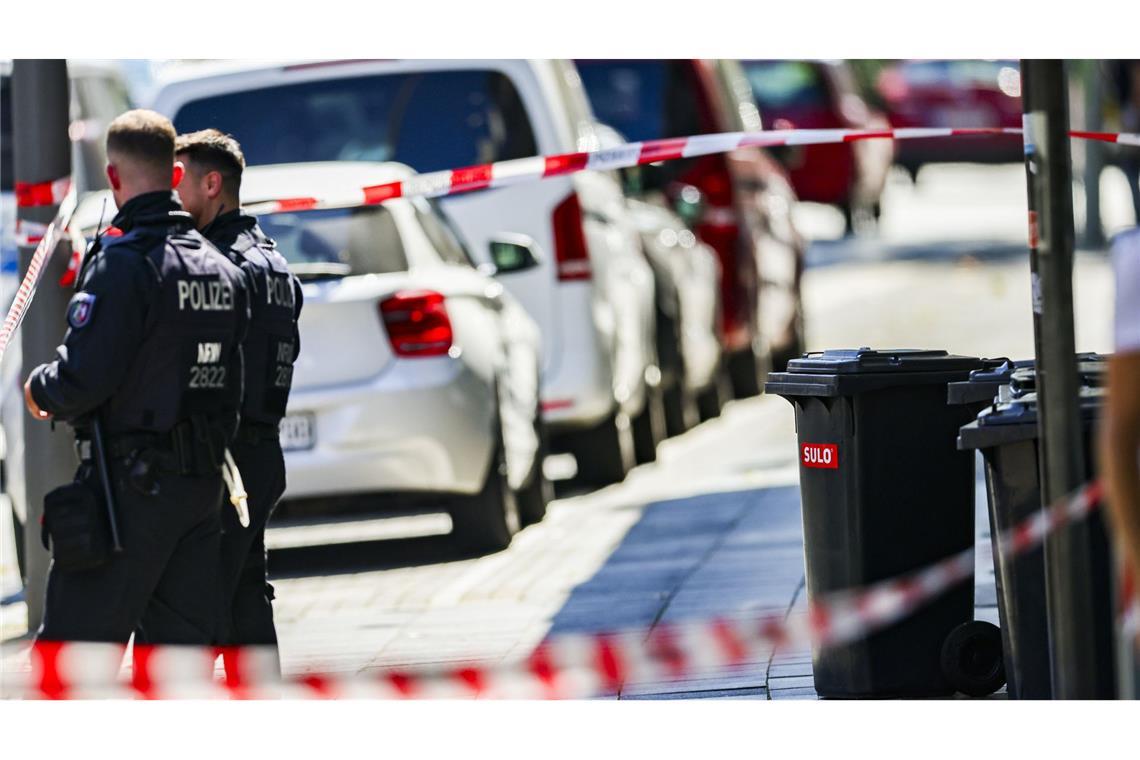 Nach der Messerattacke auf dem Solinger Stadtfest stehen Polizeibeamte neben einer Absperrung.