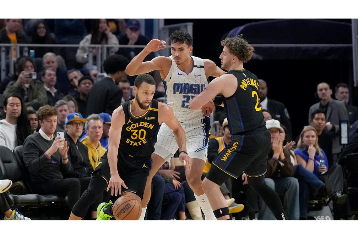 Orlandos Tristan da Silva (Mitte) sammelte gegen All-Star Stephen Curry (l.) zwei Pünktchen.