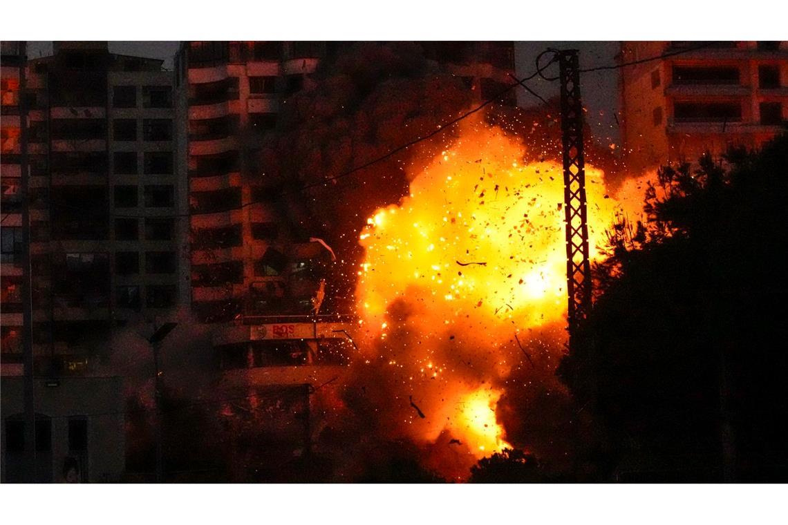 Trümmerteile fliegen durch die Gegend während eines israelischen Luftangriffs auf Gebäude in Beirut.